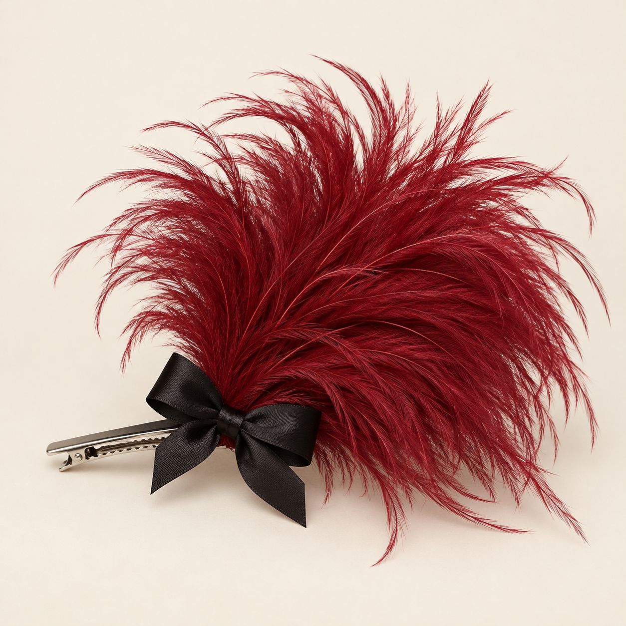 Duende Crimson: A burgundy feather tuft finished with a black satin bow.